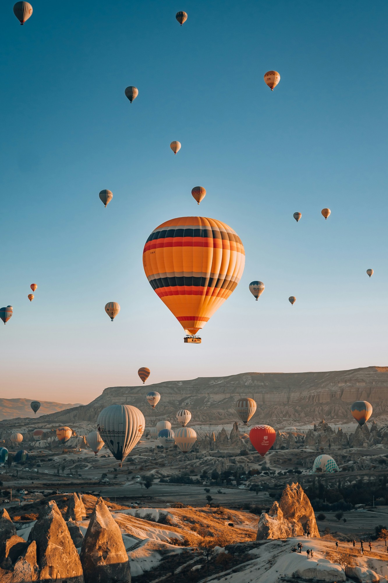 Hot air balloons over the fairy chimneys of Cappadocia at sunrise